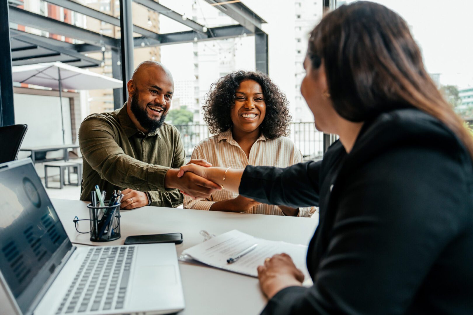 People shaking hands during a meeting.